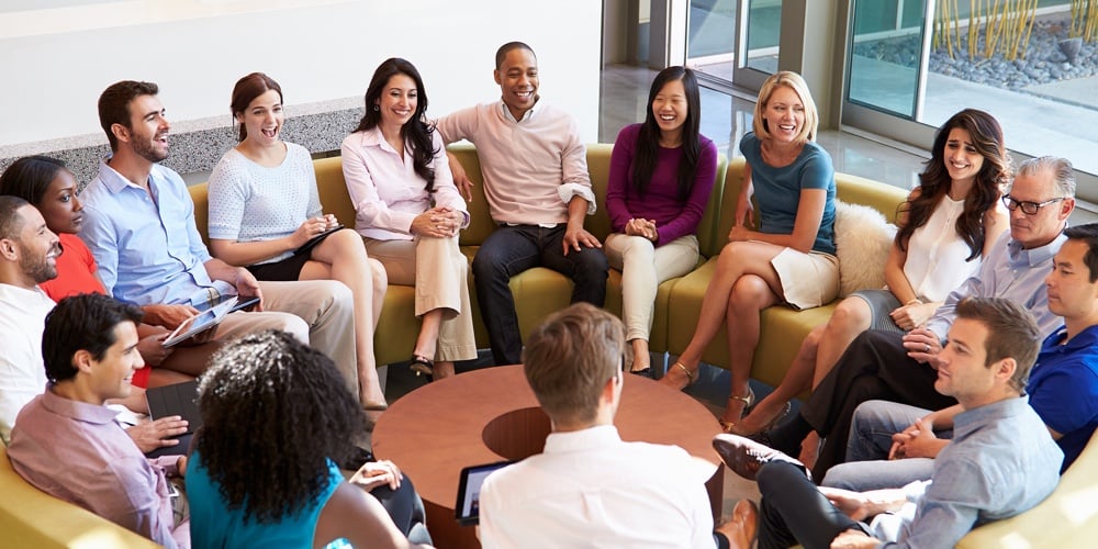 Multi-Cultural Office Staff Sitting Having Meeting Together