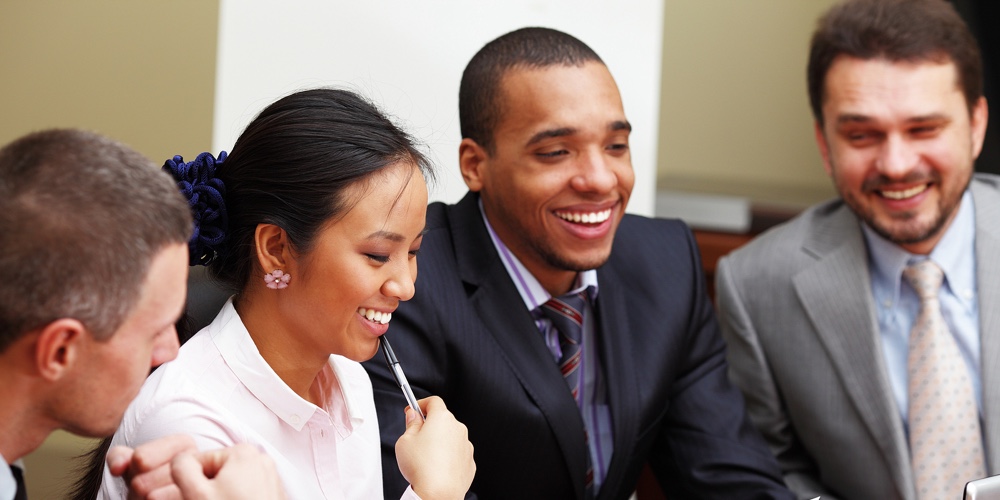 Multi ethnic business team at a meeting. Interacting. Focus on woman
