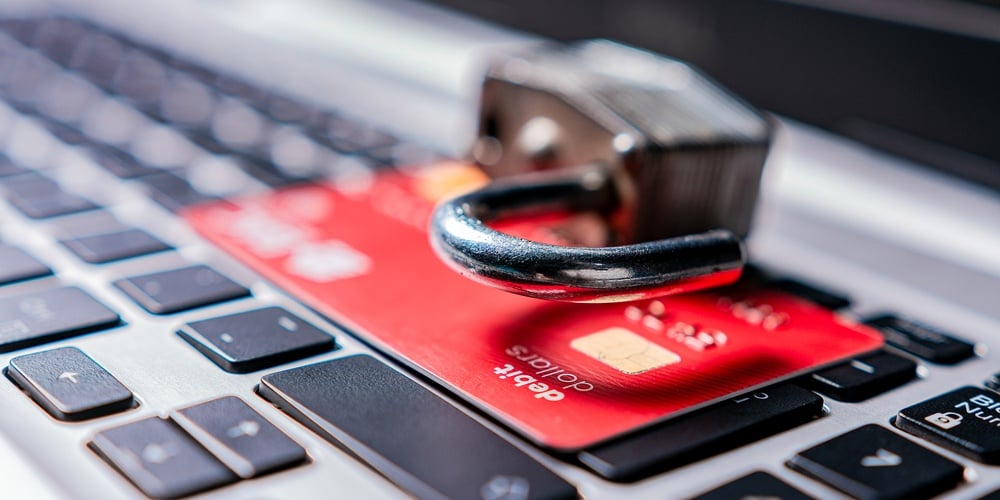 Padlock On Top Of Credit Card On Laptop Keyboard. Open Padlock With Credit Card On Keyboard. Concept