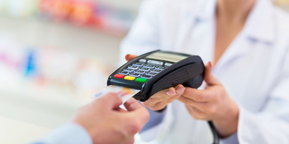 bigstock-Paying-in-the-Pharmacy-126328442