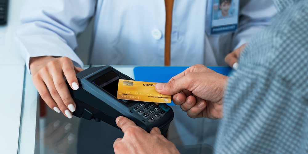 Payment By Credit Card With Payment Terminal In Qualified Drugstore Or Hospital. Modern Payment Of E