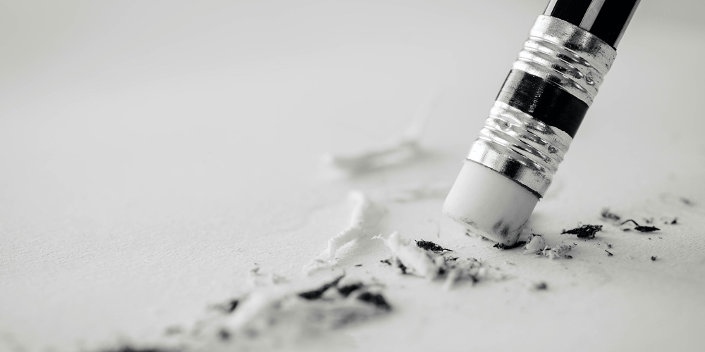 Pencil Eraser. Pencil Eraser Removing A Written Mistake On A Piece Of Paper