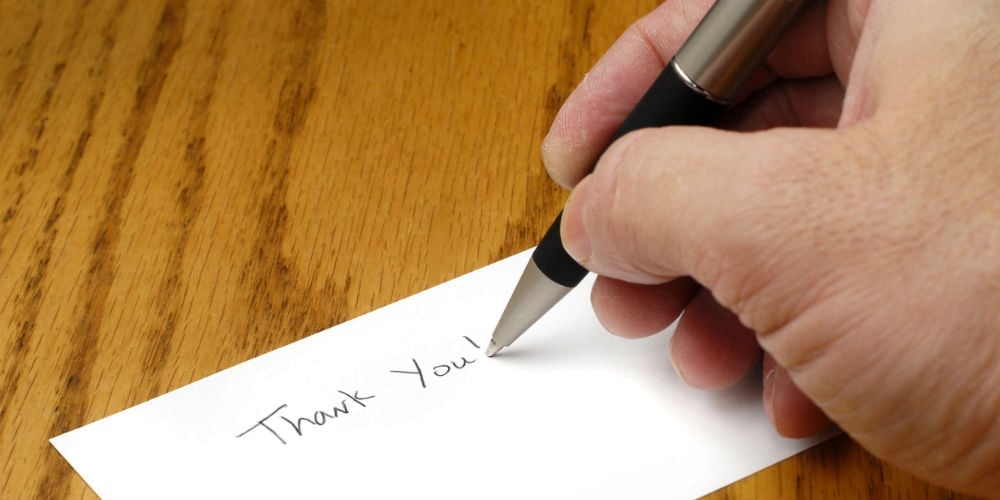bigstock-Person-writing-thank-you-note-26173676