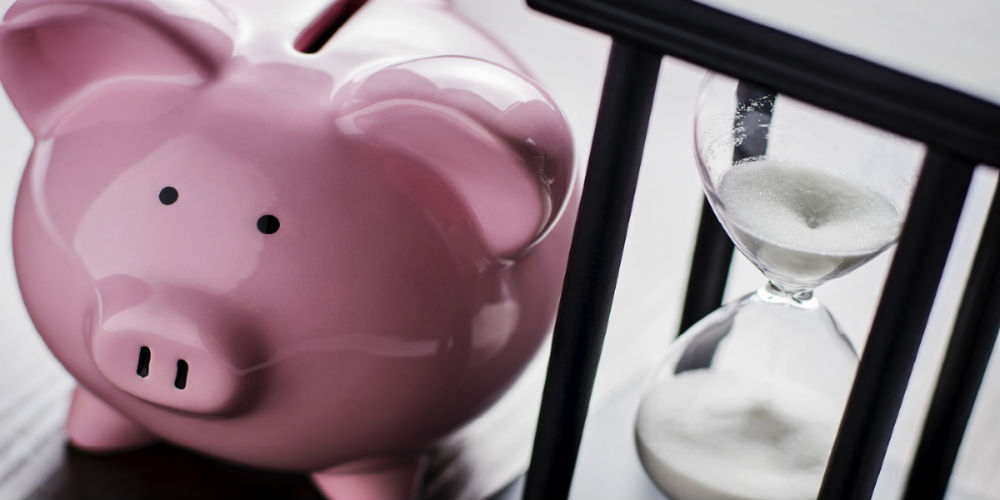 bigstock-Piggy-Bank-With-An-Hour-Glass-58495595