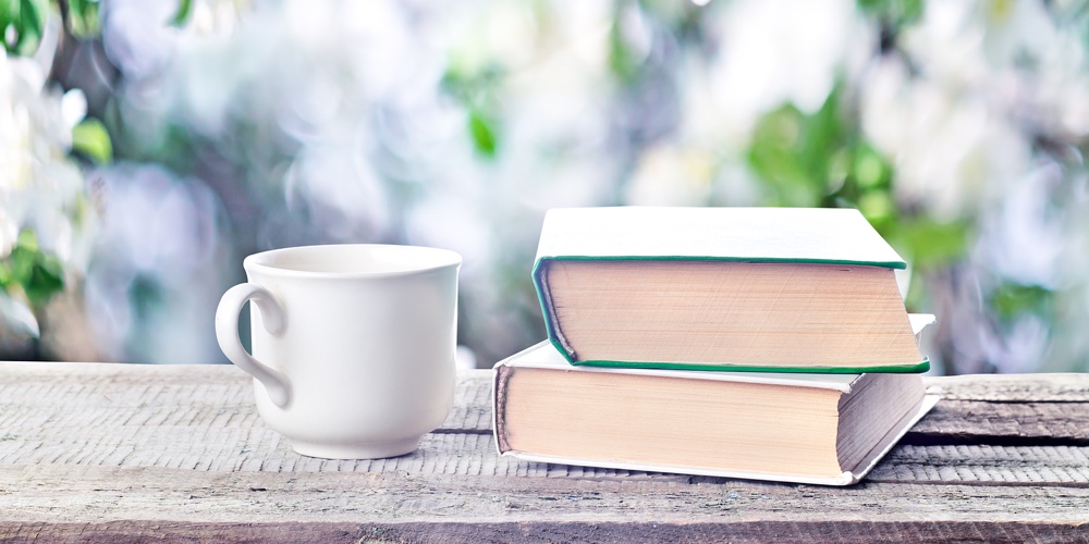 Pile Of Books, Glasses And Cup Outdoors Spring Or Summertime