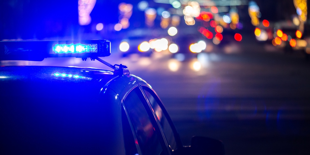 Police Car Lights At Night In City With Selective Focus And Bokeh