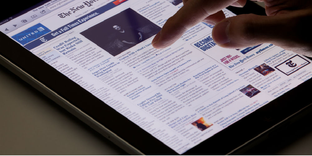 bigstock-Reading-online-newspaper-on-ip-94805951