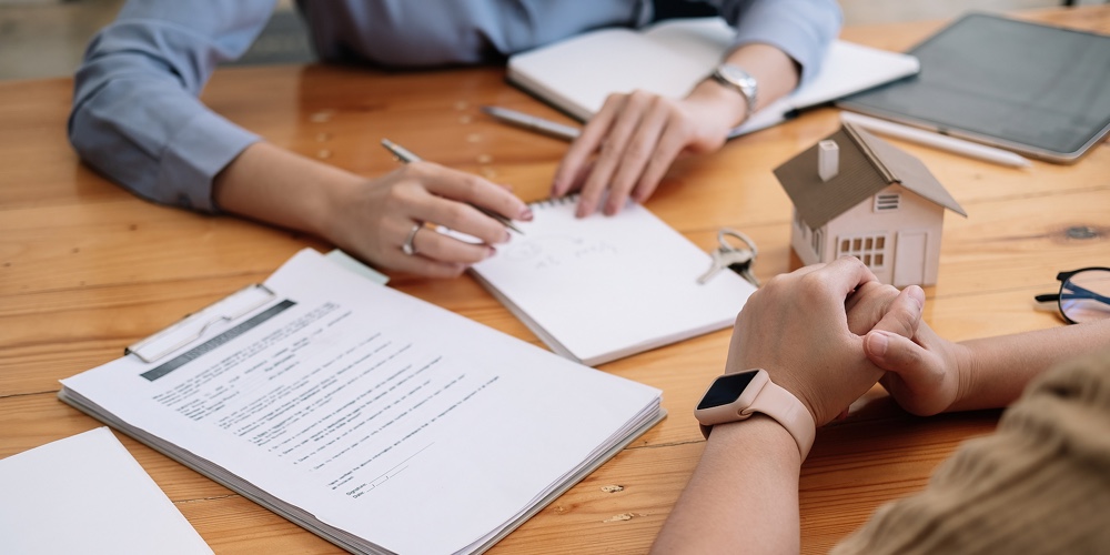 Real Estate Agent Or Bank Officer Describes The Loan Interest To The Customer With Home Purchase Con