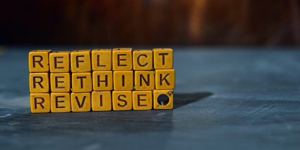 Reflect – Rethink – Revise On Wooden Blocks. Cross Processed Image With Bokeh Background