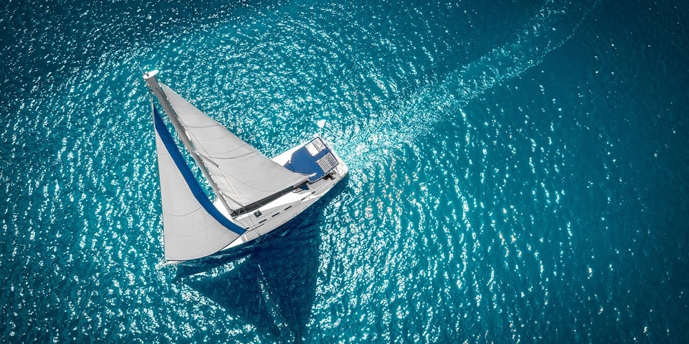 Regatta Sailing Ship Yachts With White Sails At Opened Sea. Aerial View Of Sailboat In Windy Conditi