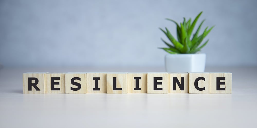 Resilience Word Concept On Cubes On Blue Background.