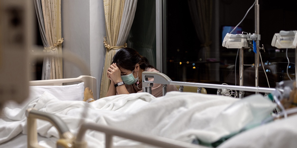 Sad Daughter Wear Face Mask Watching Over Sick Senior Mother In A Respirator