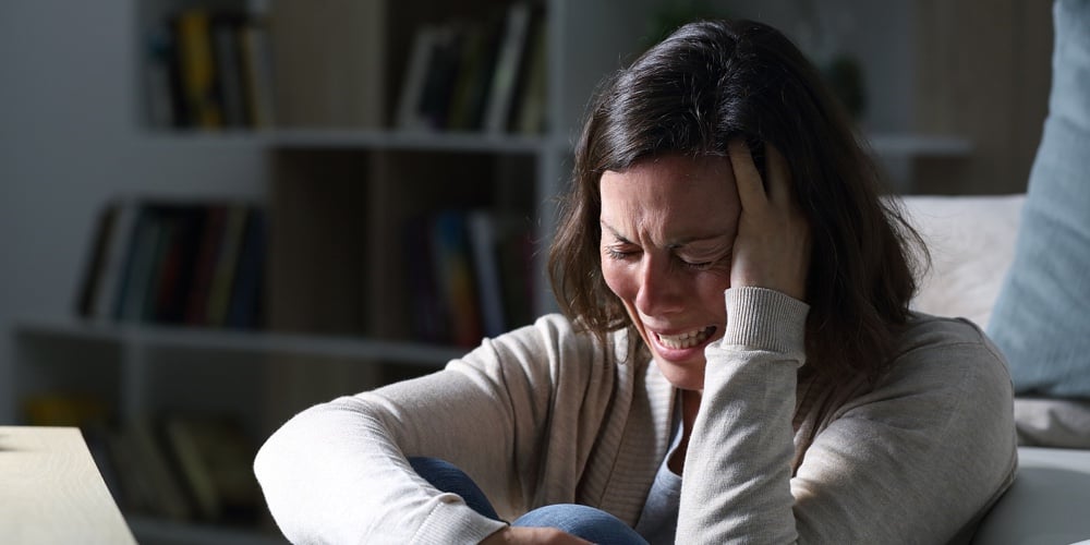 Sad Middle Age Woman Crying Sitting On The Floor In The Livingroom In The Night At Home