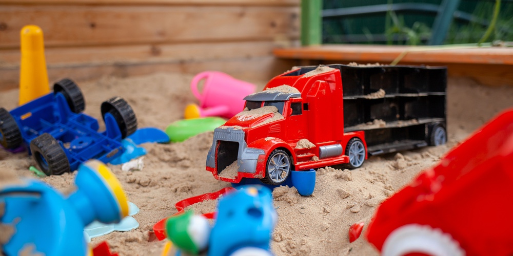 Sandbox Outdoor. Children’s Wooden Sandbox With Various Toys For The Game. Summer Concept. Colore