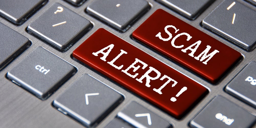 Scam Alert Text On Laptop Keyboard. Scam And Fraud Concept.