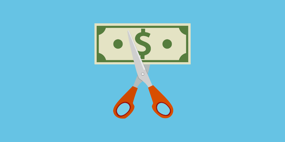 bigstock-scissors-cutting-money-bill-120986861