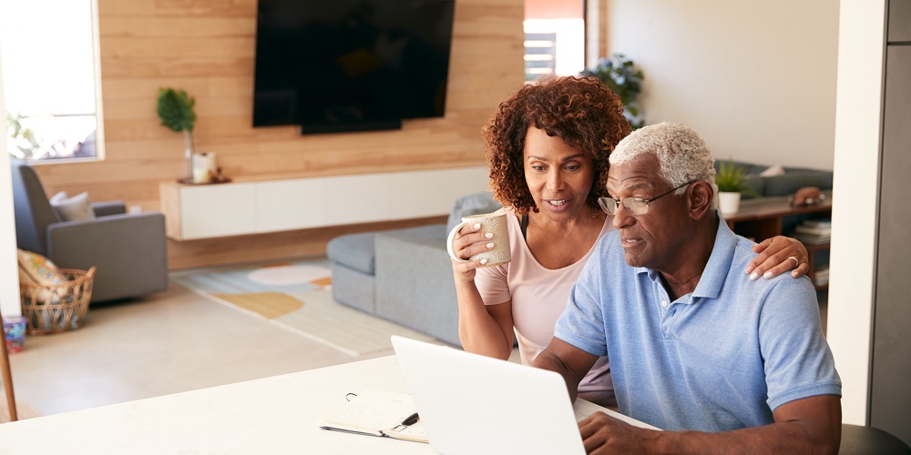 Senior African American Couple Using Laptop To Check Finances At Home