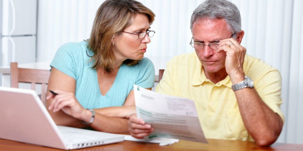bigstock-Senior-couple-looking-bills-at-82576265
