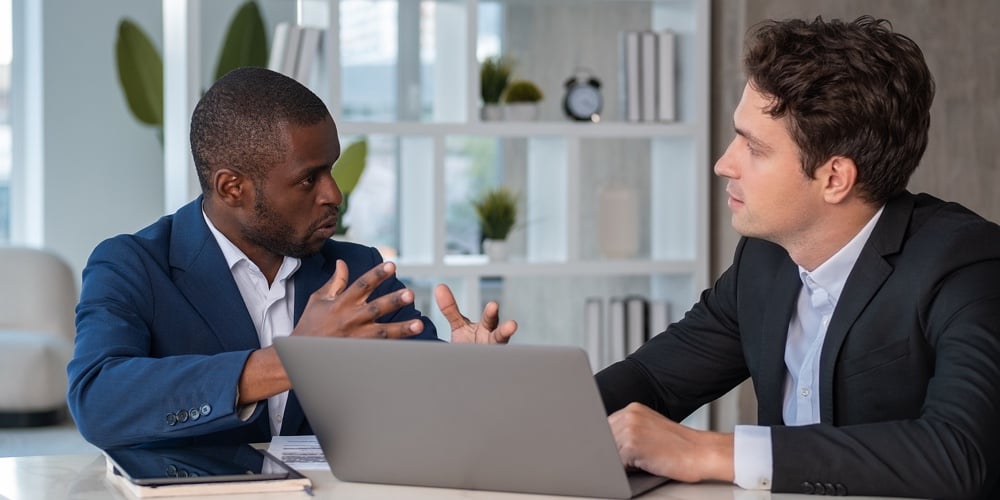 Serious African American Businessman Wearing Formal Suit Talking To Colleague Discussing Working Mom