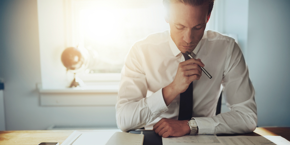 bigstock-Serious-Business-Man-Working-O-108210065