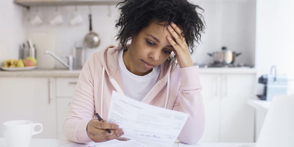 Single Young African American Female With Many Debts Feeling Stressed, Calculating Finances, Siting