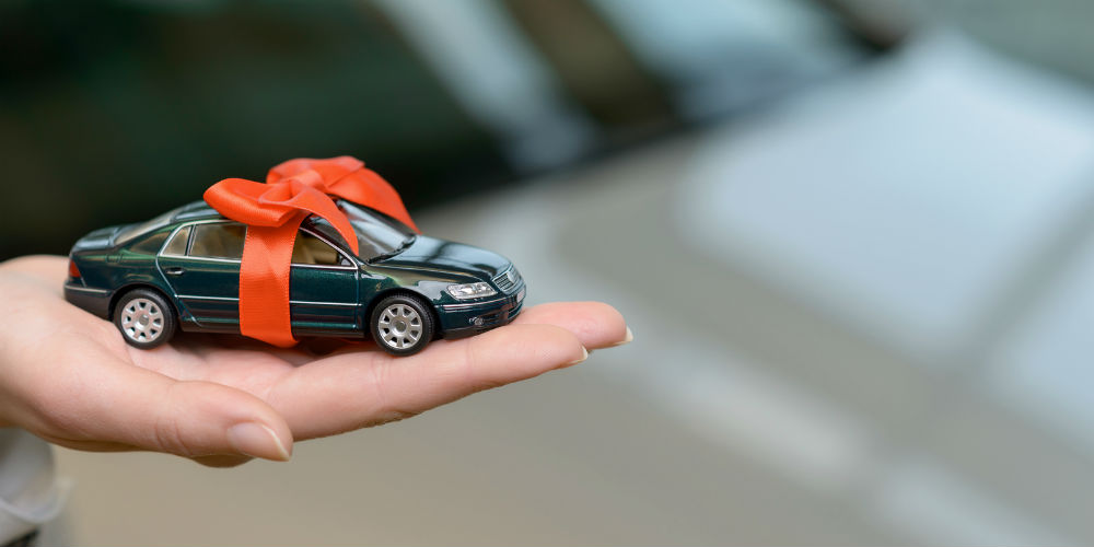 bigstock-Small-souvenir-car-on-saleswom-108852668