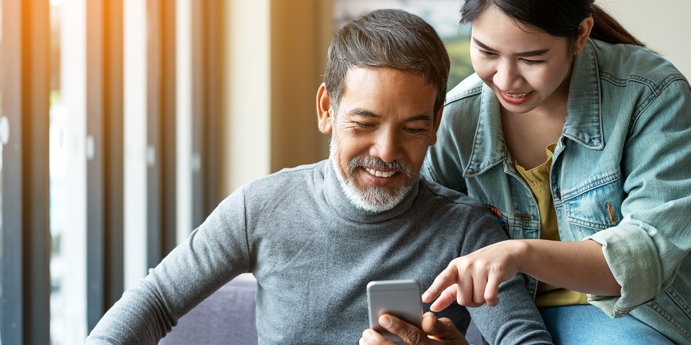 Smile Attractive Stylish Short Beard Mature Asian Man Using Smartphone With Young Woman. Daughter Te