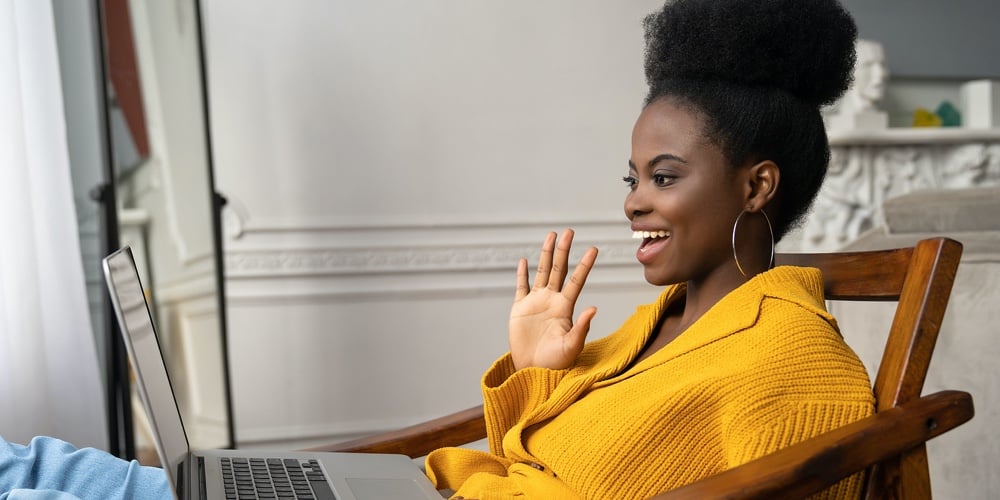 Smiling African American Biracial Millennial Woman With Afro Hairstyle In Yellow Cardigan Resting