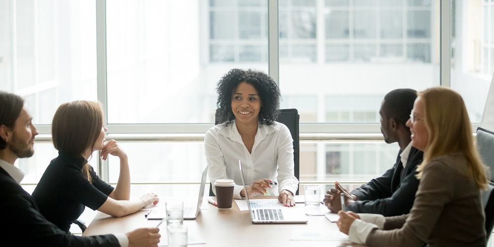 Smiling Friendly African Female Boss Leading Corporate Diverse Team Meeting Talking To Multiracial P