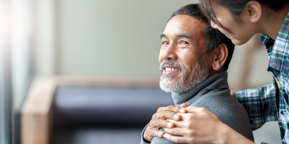Smiling Happy Older Asian Father With Stylish Short Beard Touching Daughter’s Hand On Shoulder Looki