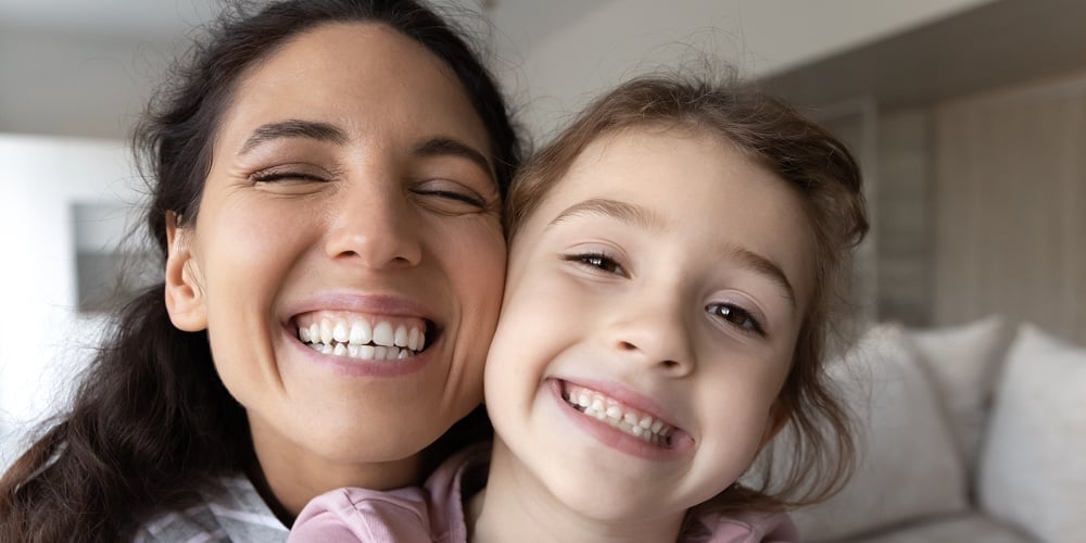 bigstock-Smiling-Hispanic-Mom-And-Daugh-423551960