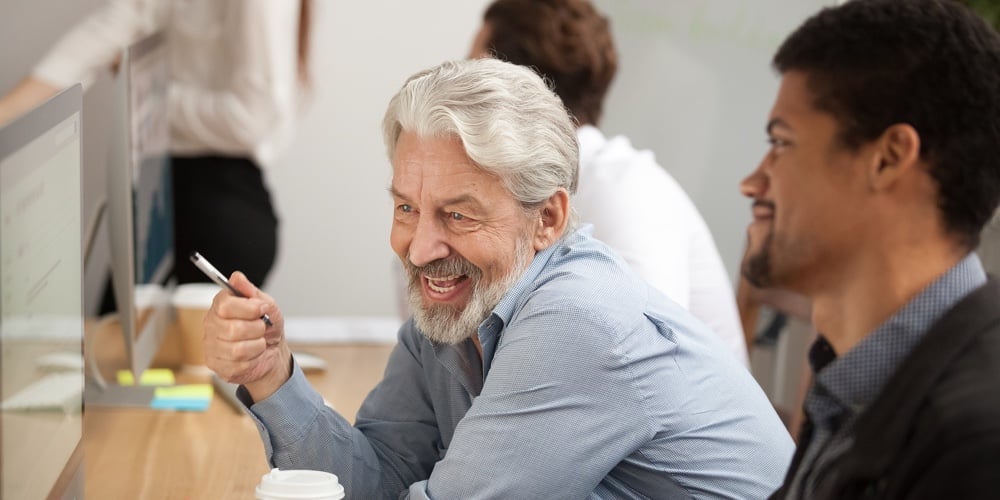 bigstock-Smiling-Senior-Employee-Discus-230327548