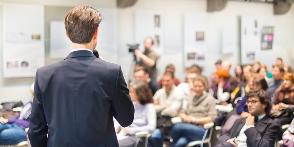 bigstock-Speaker-Talking-at-Business-Co-85436360-e1450786677254