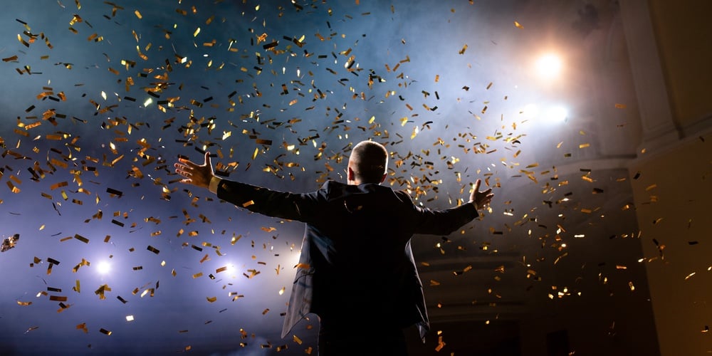 Successful Businessman With Arms Up Celebrating His Victory. Celebrating Success. Low Angle View Of