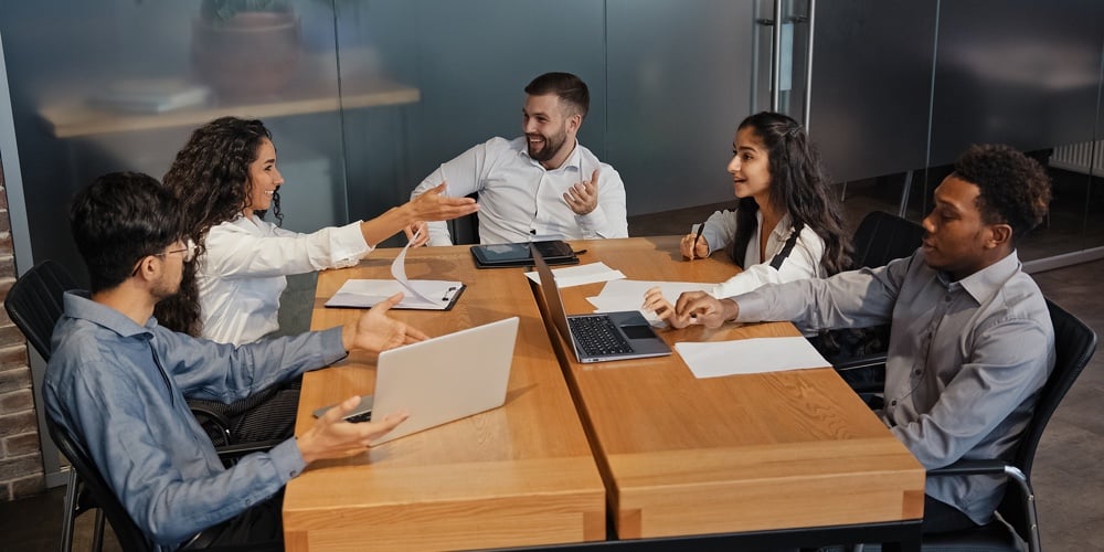 Successful Multiethnic Colleagues Discussing Idea Project In Office Boardroom Meeting. Multiracial B