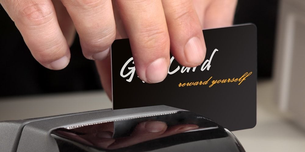 bigstock-Swiping-A-Card-Through-A-Termi-3929676-e1674230344771