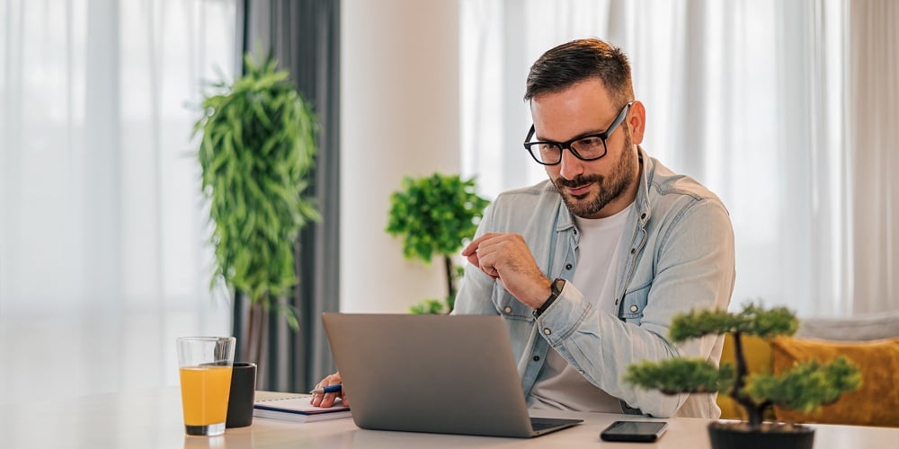 Talking Notes And Looking At Laptop Computer At Home Office. Handsome Young Adult Man Casual Busines|Young African American Girl Student Studying Virtual Course