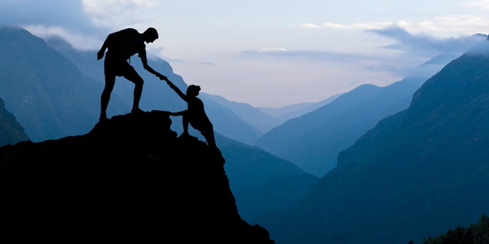 bigstock-Teamwork-Couple-Climbing-Helpi-91037114