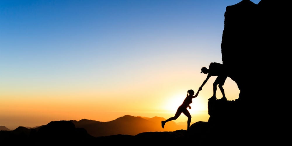bigstock-Teamwork-Couple-Climbing-Helpi-98413964