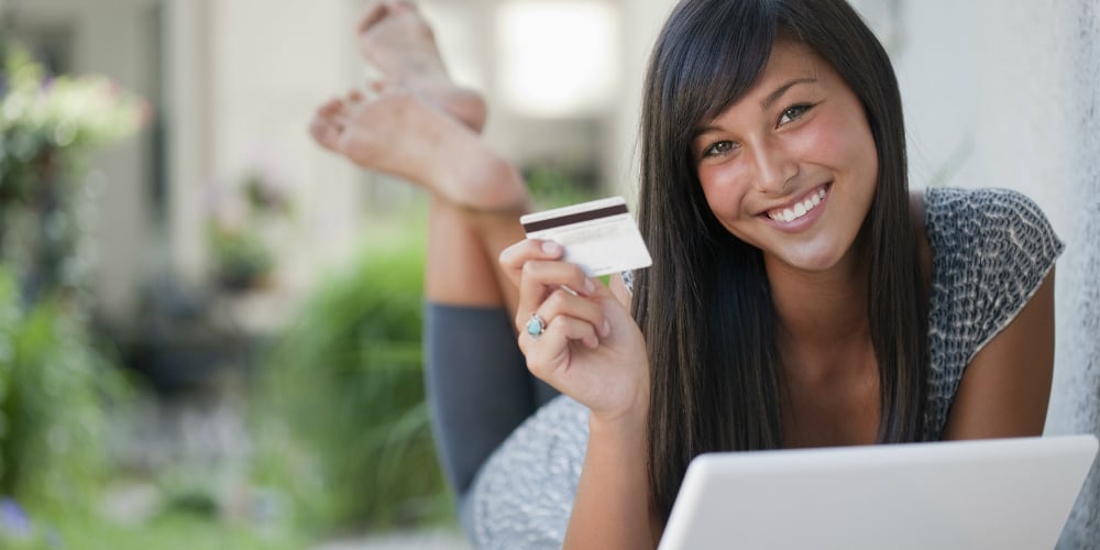 bigstock-Teen-Using-Credit-Card-And-Lap-7081246