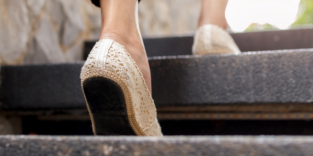 The Adult Woman Walking Up The Stairs.