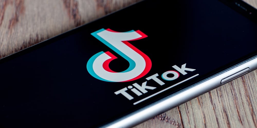 Tiktok Application Icon On Apple Iphone 11 Screen Close-up. Hand Holding Smartphone Tik Tok Icon On