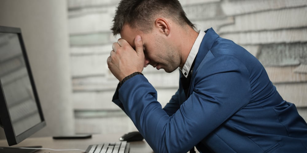 bigstock-Tired-Business-Man-At-Workplac-154938857