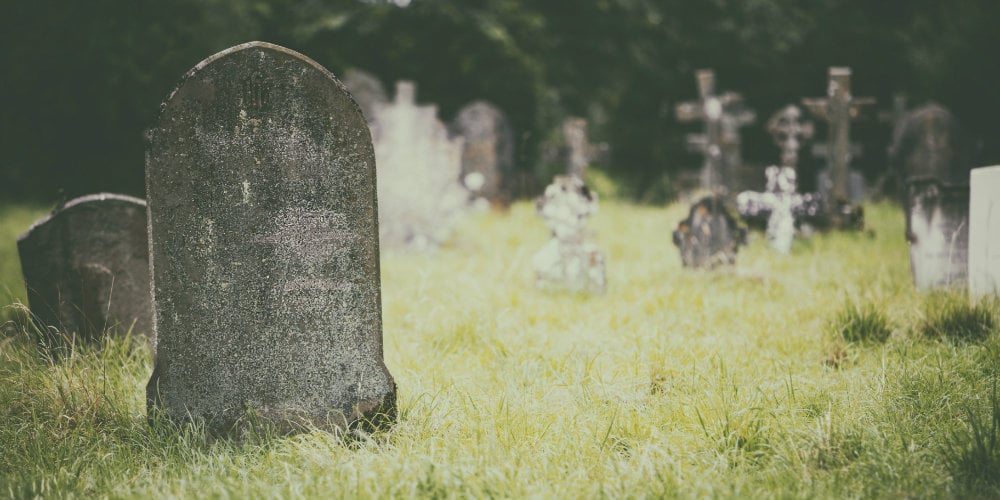 bigstock-Tombstone-and-graves-in-an-anc-154497446