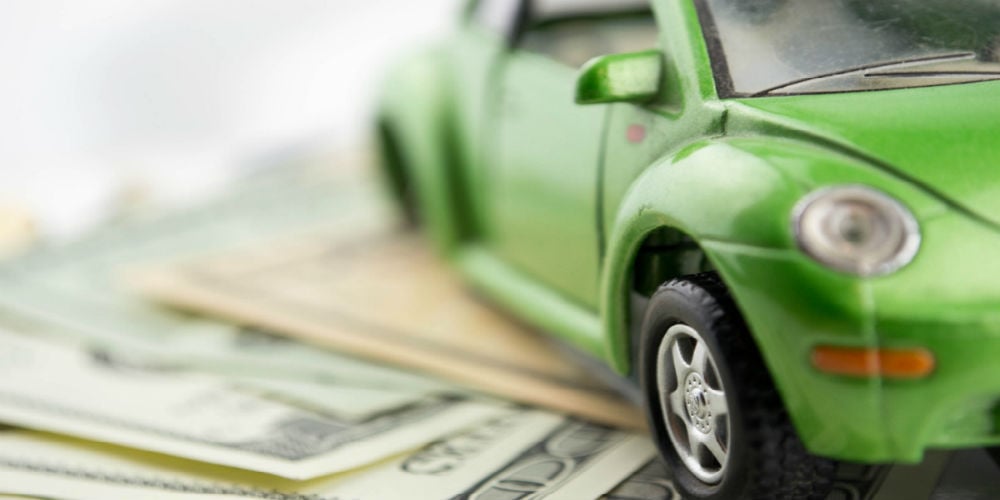 bigstock-Toy-car-and-money-over-white-49217057