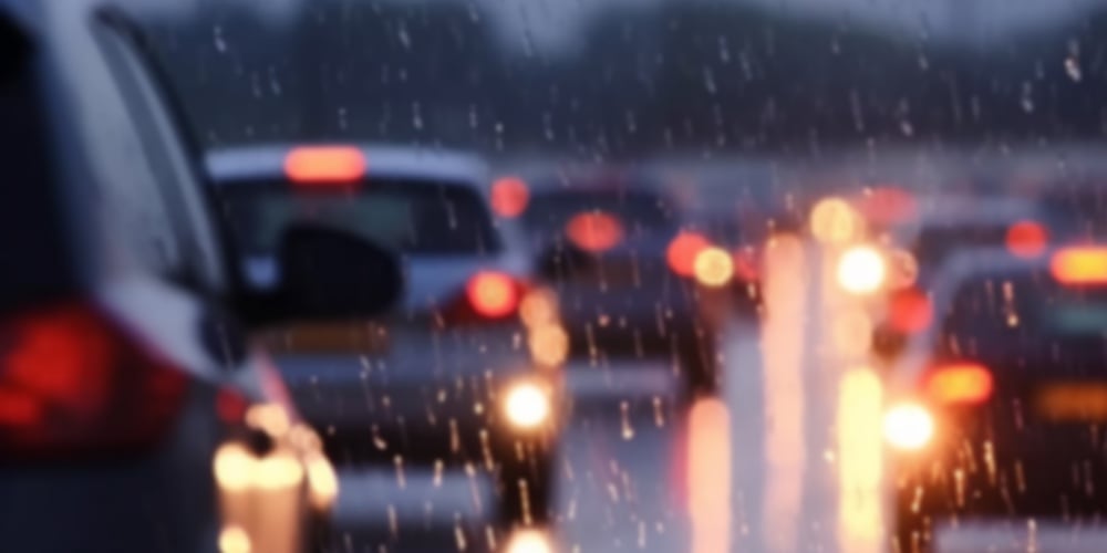 Traffic Jam Heavy On Highway On Rainy Day With Raindrops On Car Glasses. Blurred Background
