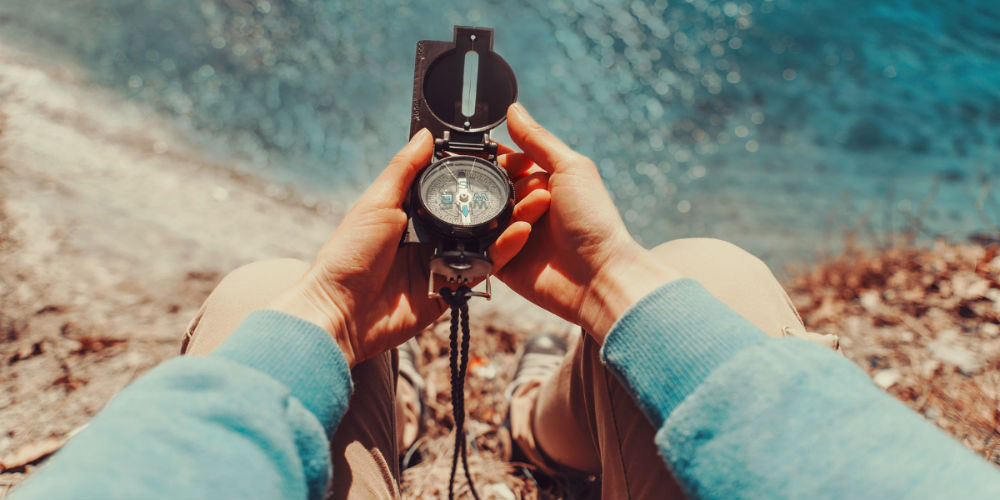 bigstock-Traveler-Holding-A-Compass-On–86840801