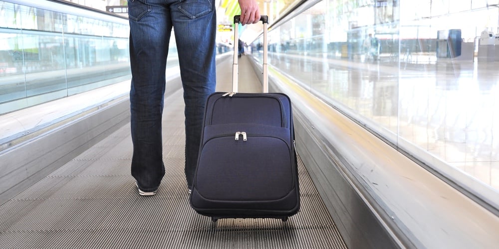 Traveler with a bag at the speedwalk