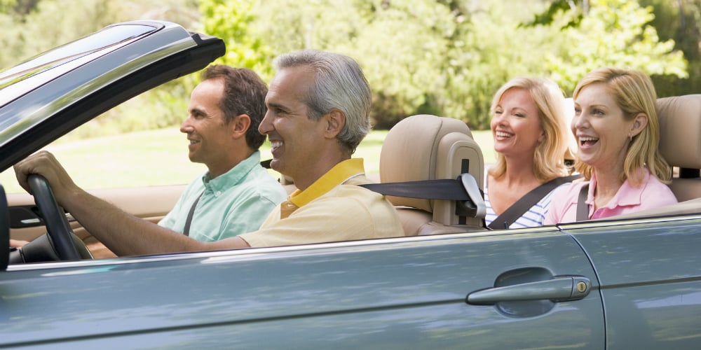 bigstock-two-couples-in-convertible-car-4133083