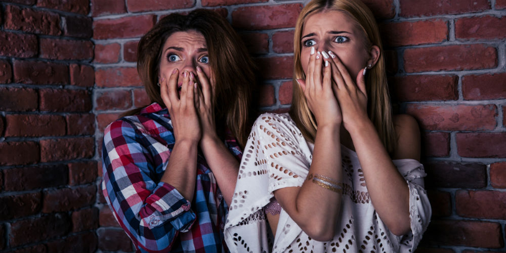 bigstock-Two-scared-woman-standing-with-95905472